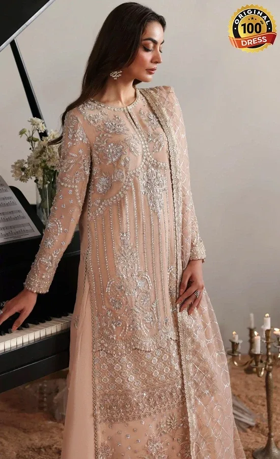 Embroidered pink salwar kameez for wedding guests with chatta patti, tassels and traditional detailing