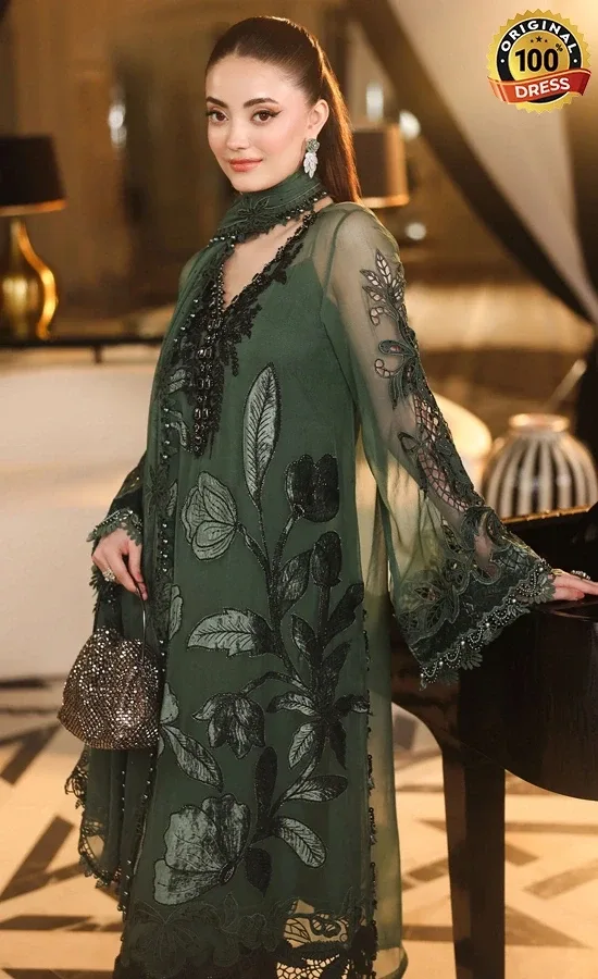 Pakistani dark green salwar kameez for wedding guests with intricate embroidery and graceful formal styling