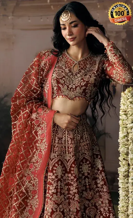 Orange raw silk lehenga choli with organza details, small pearls and intricate embroidery