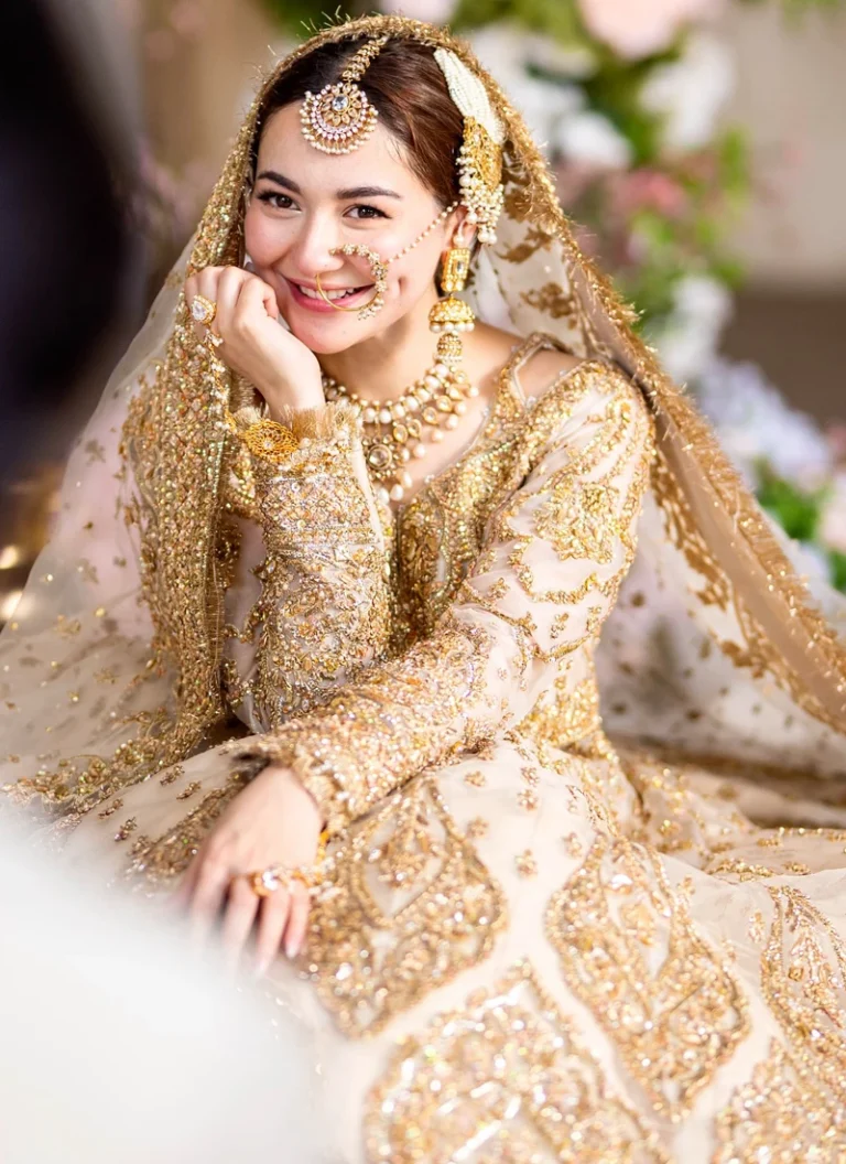 White and Gold Bridal Lehenga – Pakistani Wedding Dress White and gold bridal dress featuring an embroidered dupatta with delicate motifs, wide decorative borders and tasselled corners