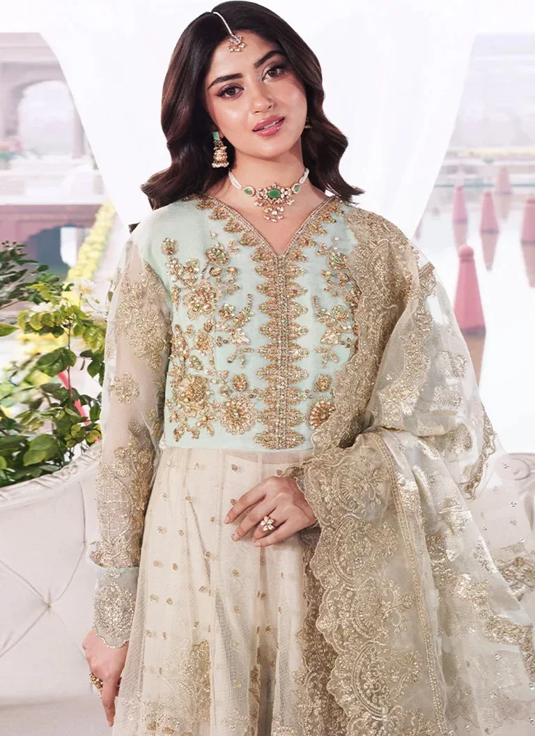 Green Pakistani wedding guest maxi dress with intricate embroidery and sophisticated formal styling