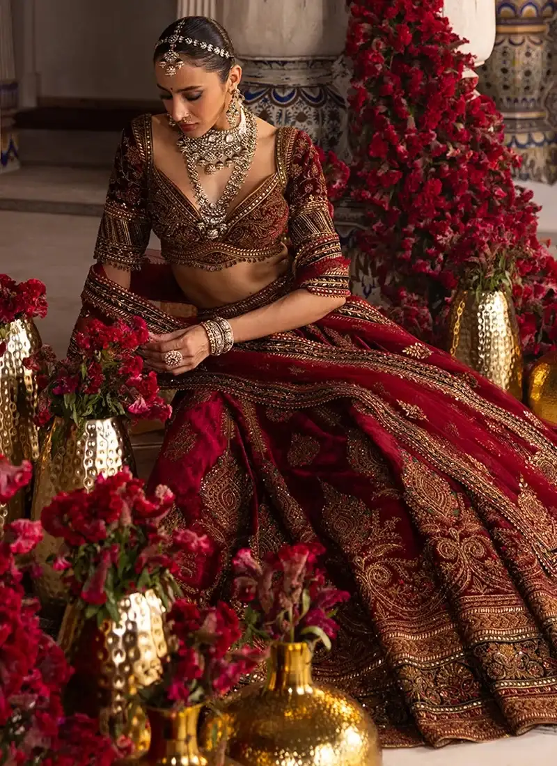 Deep maroon Indian velvet bridal lehenga choli with antique gold paisley embroidery