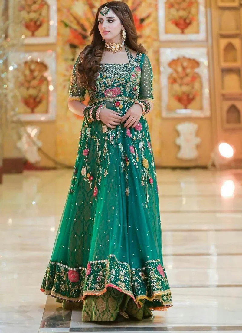 Emerald green bridal lehenga Pishwas with floral detailing and intricate crystal embellishments