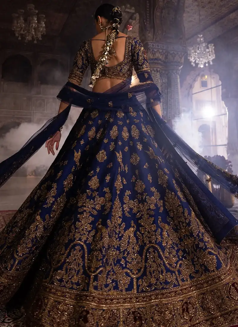 Indian bridal lehenga in navy blue with gold kora dabka work and decorative peacock motifs