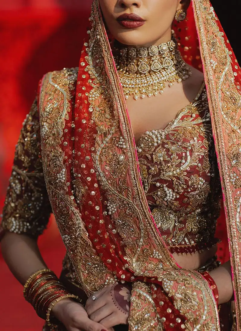 Nomi Ansari red Walima outfit with panelled lehenga, layered embroidered hem and deep V neckline
