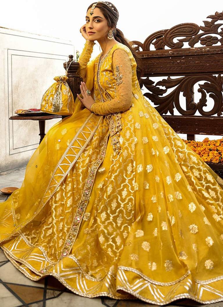Pakistani yellow Angrakha frock with lehenga featuring traditional embroidery and graceful wedding wear design