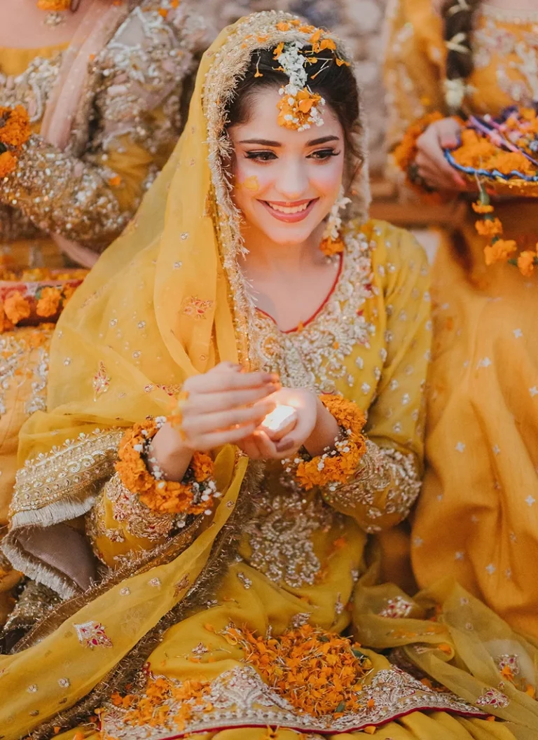 Pakistani yellow Mehndi bridal outfit with embroidered net shirt and traditional sharara styling