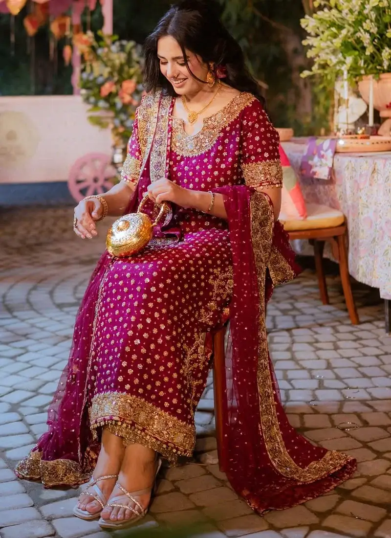 Plum purple formal dress featuring intricate gold zardozi embroidery and elegant Pakistani styling