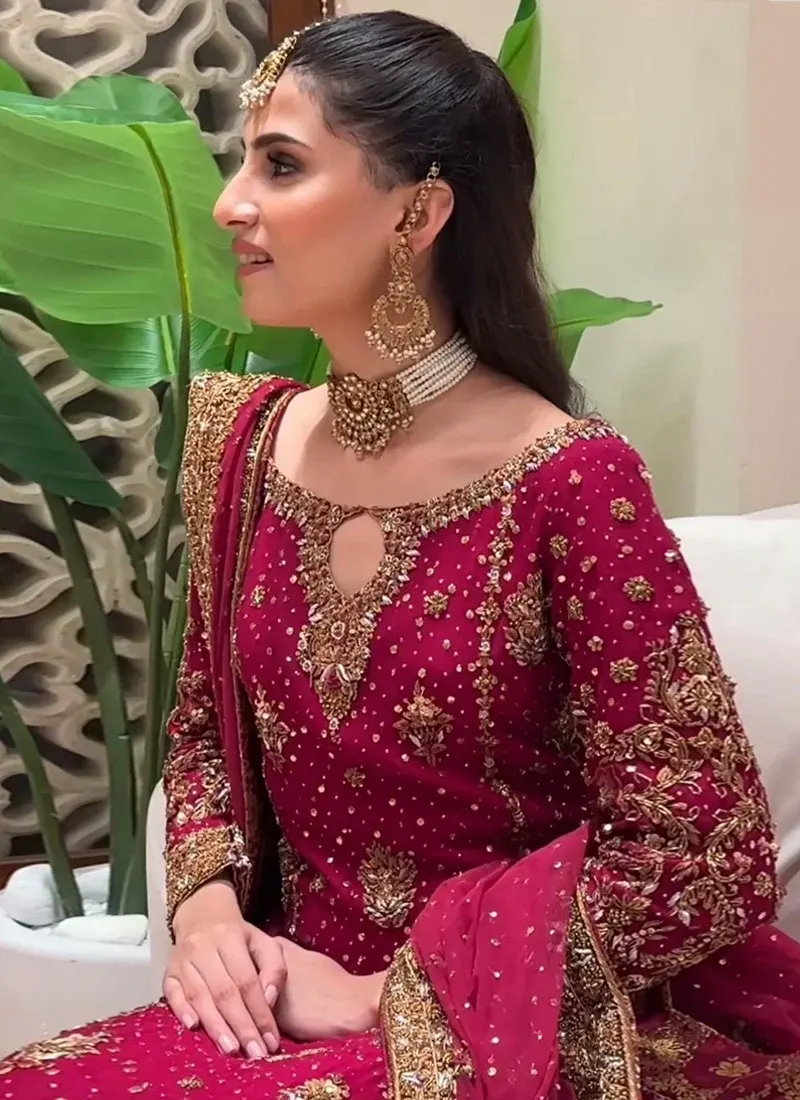 Ruby red wedding guest formal dress with gold zardozi embroidery and graceful Pakistani styling