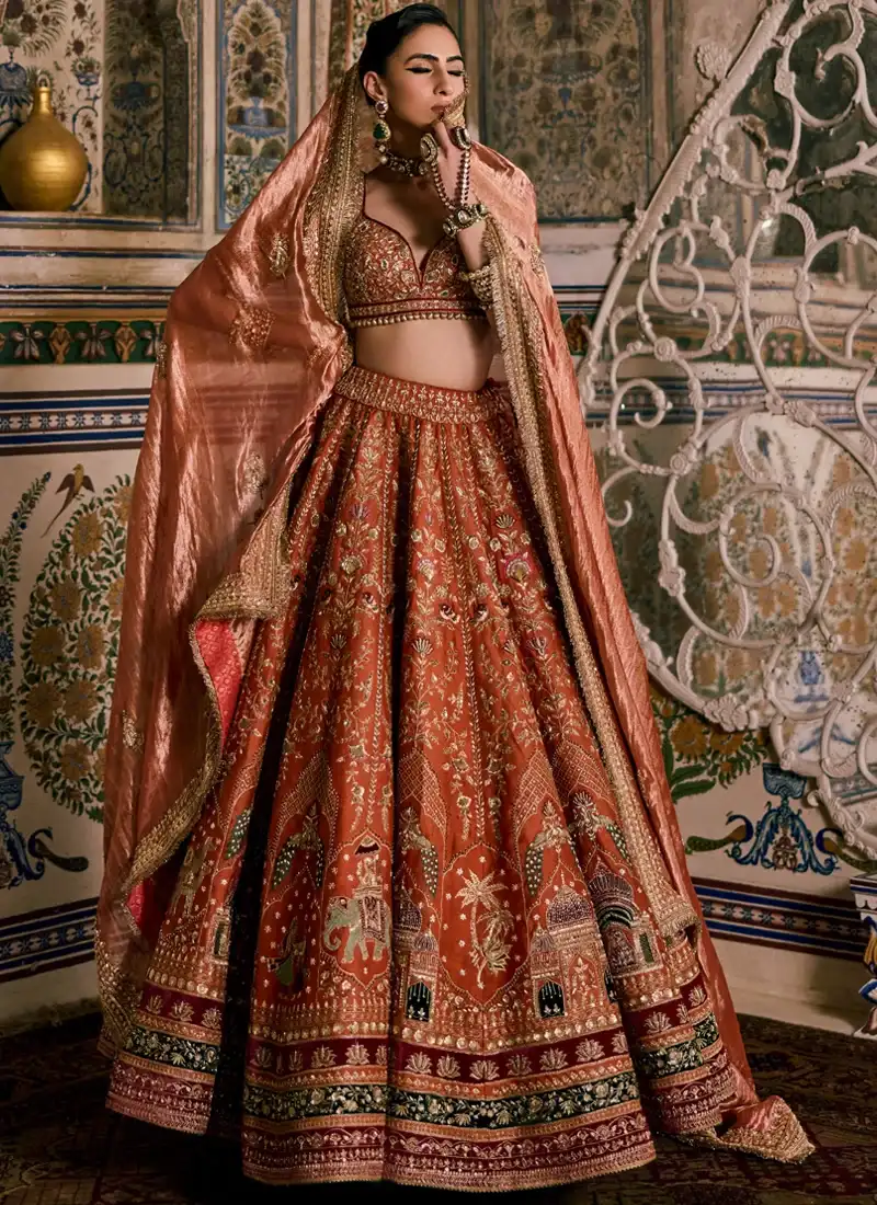 Rust brown Indian bridal lehenga choli with intricate zardozi and resham embroidery