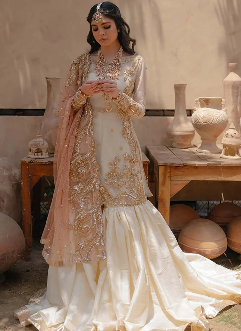 White tissue silk gharara with circular full ghera under a boat-neck organza kameez