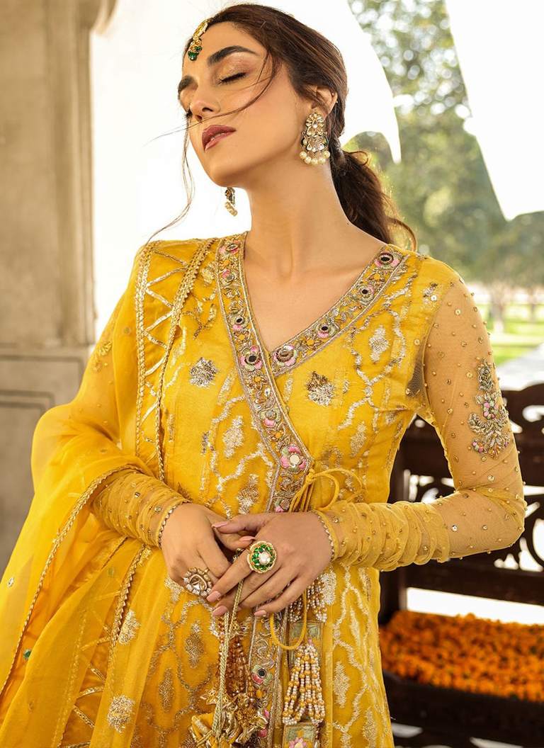 Yellow Mehndi Angrakha lehenga dress with intricate embroidery and elegant festive detailing