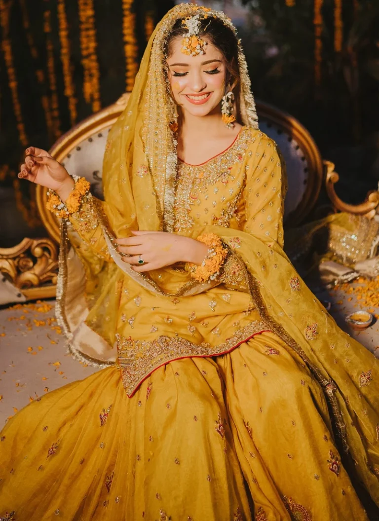 Yellow Mehndi dress for bride with heavy hand embellishment and traditional bridal detailing