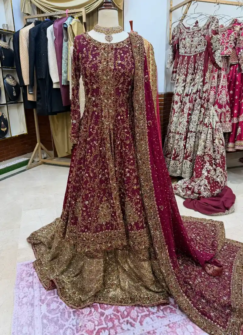 Burgundy front-slit bridal gown full-length view over a bronze-gold farshi lehenga
