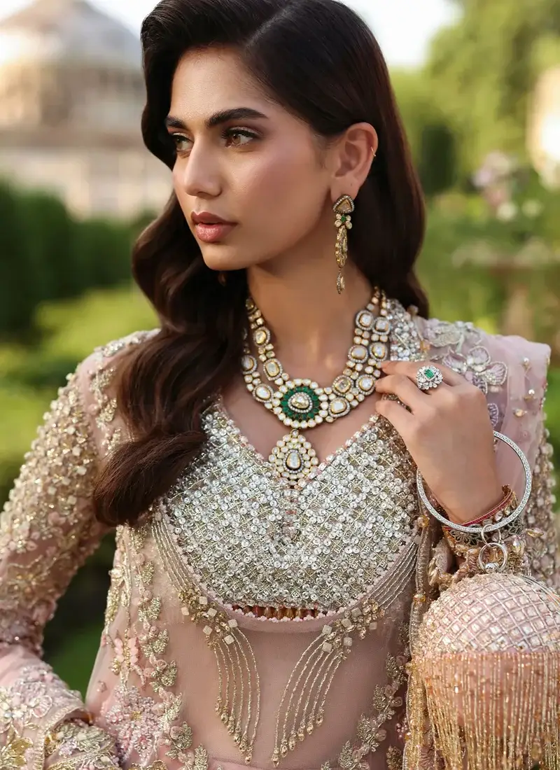 Dusty pink bridal lehenga full-length view with floral shirt border and diamond-patterned skirt hem