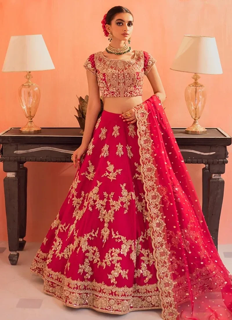 Fuchsia Baraat Lehenga Choli with Gold Floral Arches Fuchsia bridal lehenga choli front view with gold floral garlands and a sheer dotted dupatta