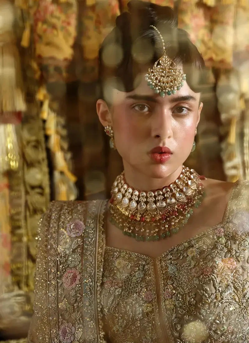 Taupe-gold bridal pishwas close-up showing a notched neckline, metallic floral embroidery and bordered dupatta