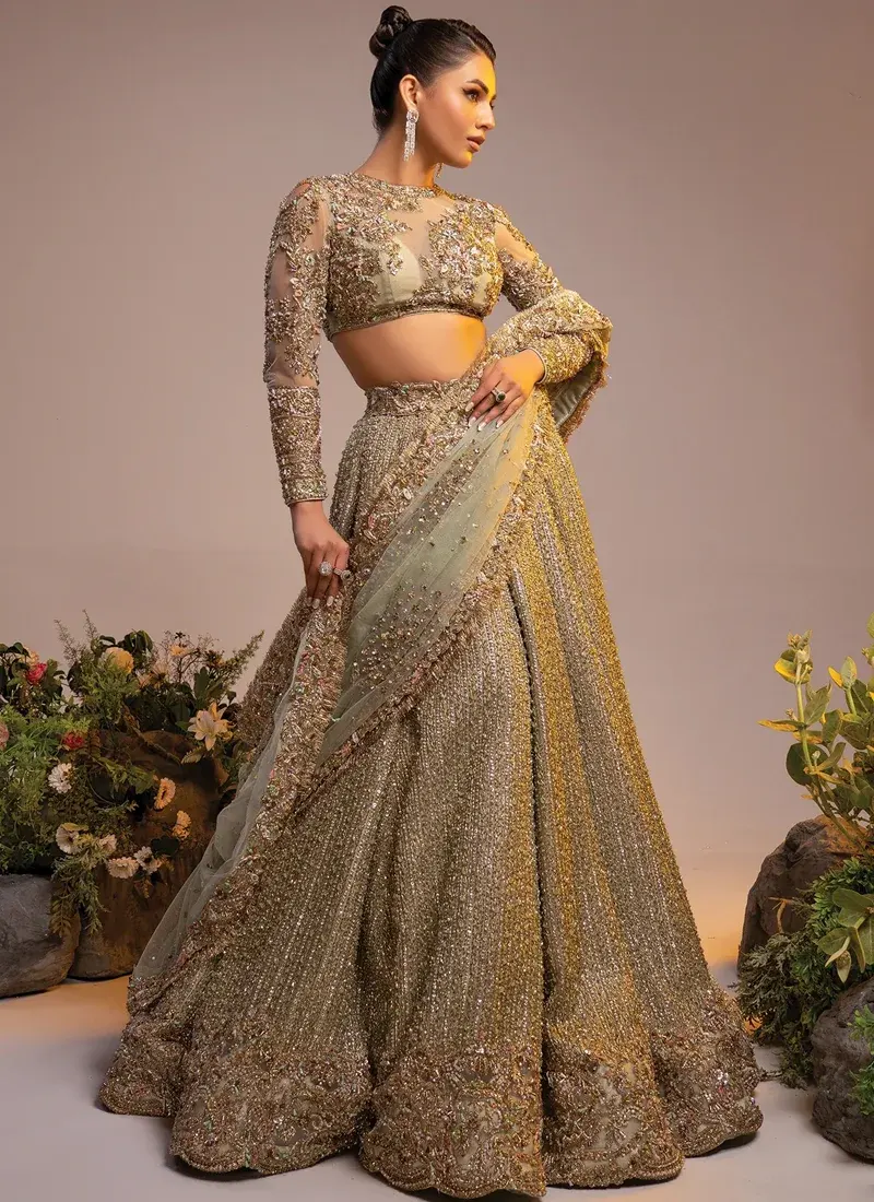 Gold lehenga choli front close-up showing sheer floral blouse and embellished sage dupatta edge