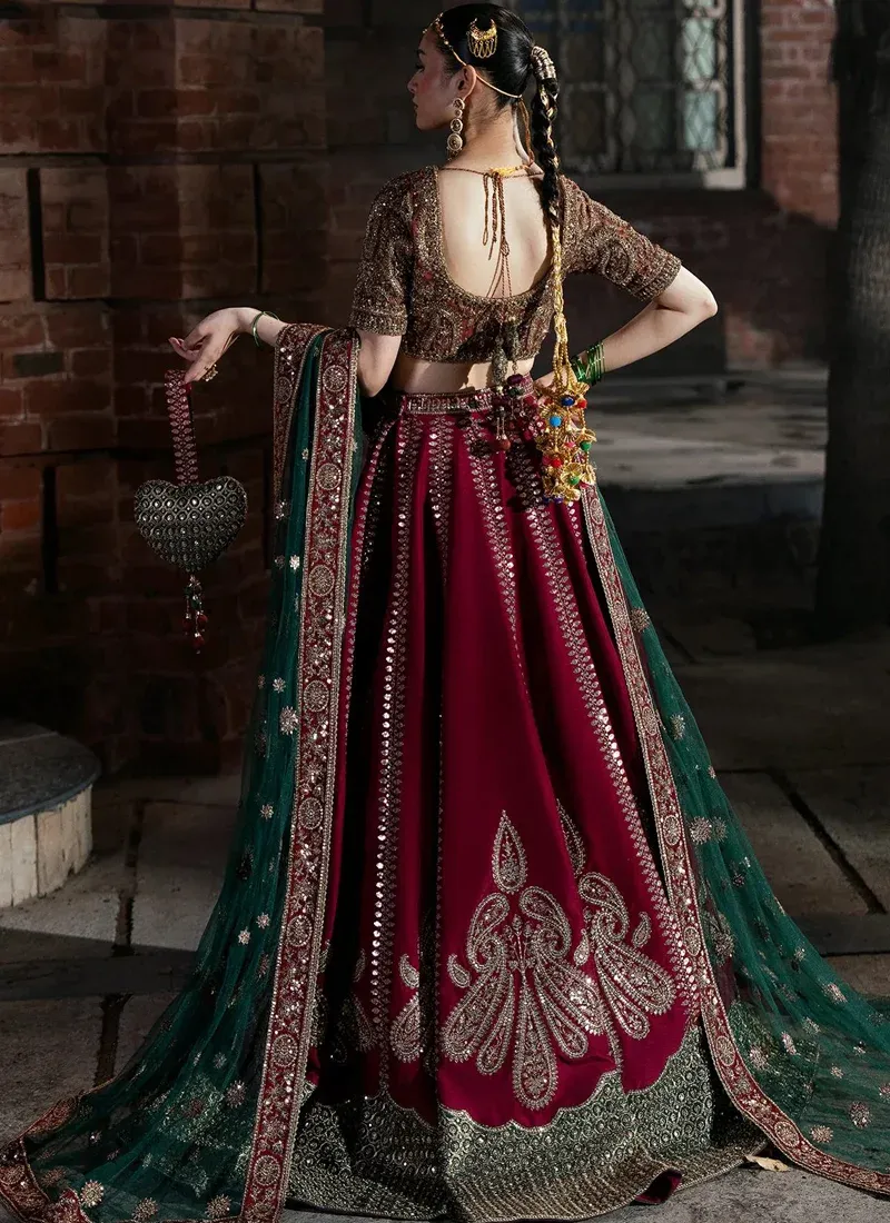 Hot pink bridal lehenga choli, front view with oversized gold paisleys and a sheer teal dupatta