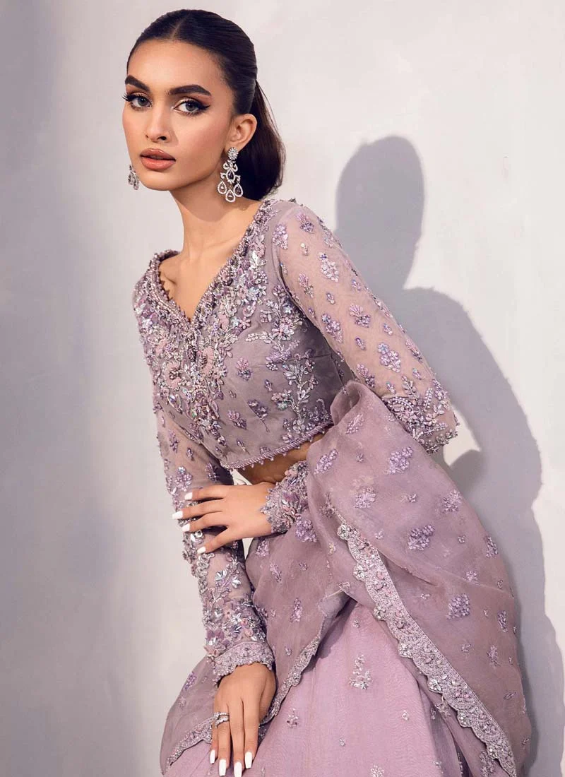 Lilac lehenga saree blouse close-up showing notched neckline and pearl-studded floral embroidery