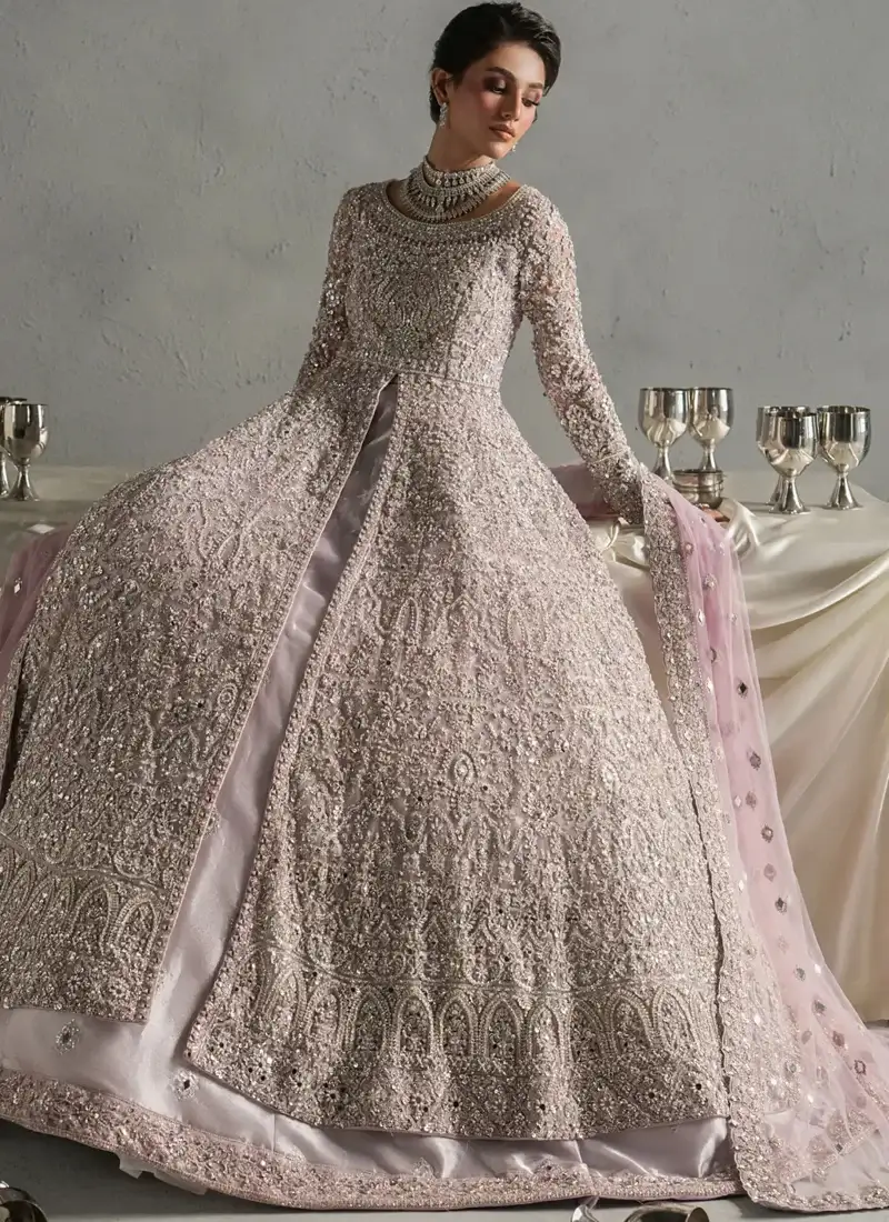Dusty lilac bridal gown with spread flared skirt, ornate arch motifs and exposed silk lehenga hem