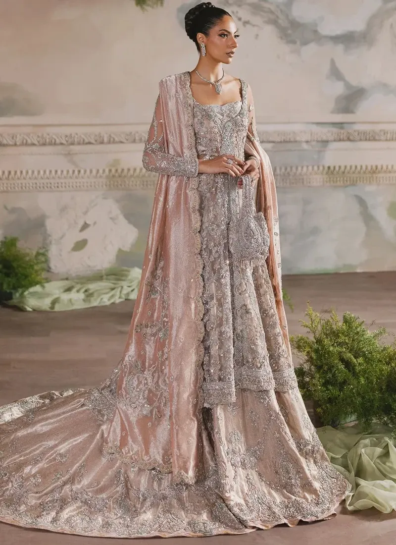 Peach bridal farshi lehenga front view with silver floral embroidery and a sweeping back train