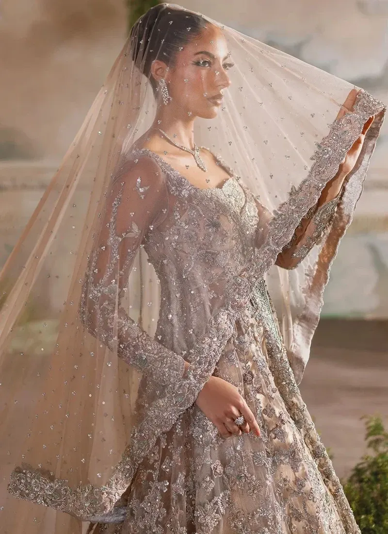 Peach walima farshi lehenga front view with a glossy pink dupatta and silver embroidered train