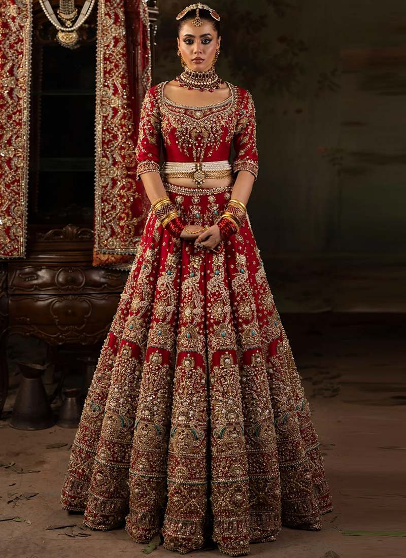 Red Baraat Lehenga Choli with Turquoise Beaded Medallions Red bridal lehenga choli side view with gold embroidered sleeves and sheer bordered net dupatta
