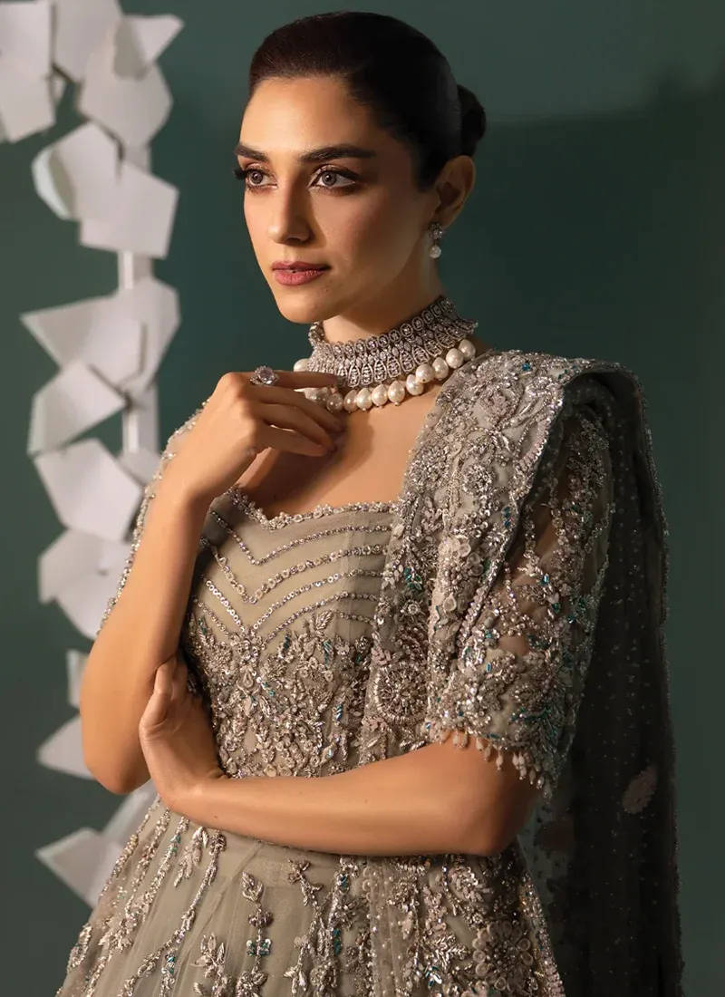 Sage green bridal gown back view with a sheer crystal-dotted panel and silver embroidered dupatta.