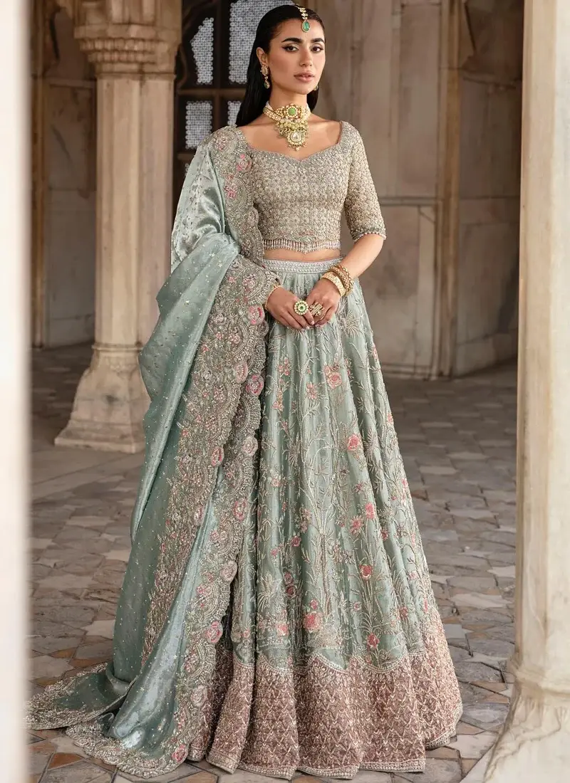Sage green lehenga choli, three-quarter full view with a flared floral skirt and floor-draped dupatta.