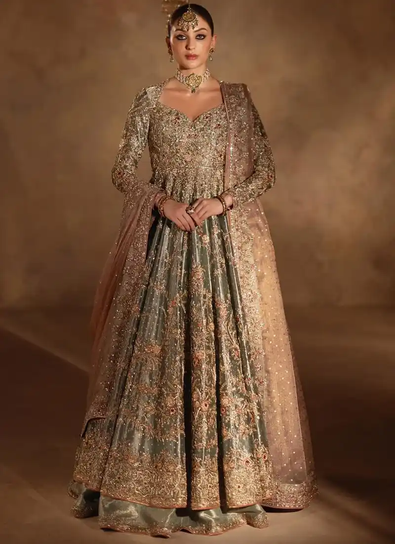 Sage green long bridal peshwas in three-quarter view with gold floral hem and dusty pink dupatta