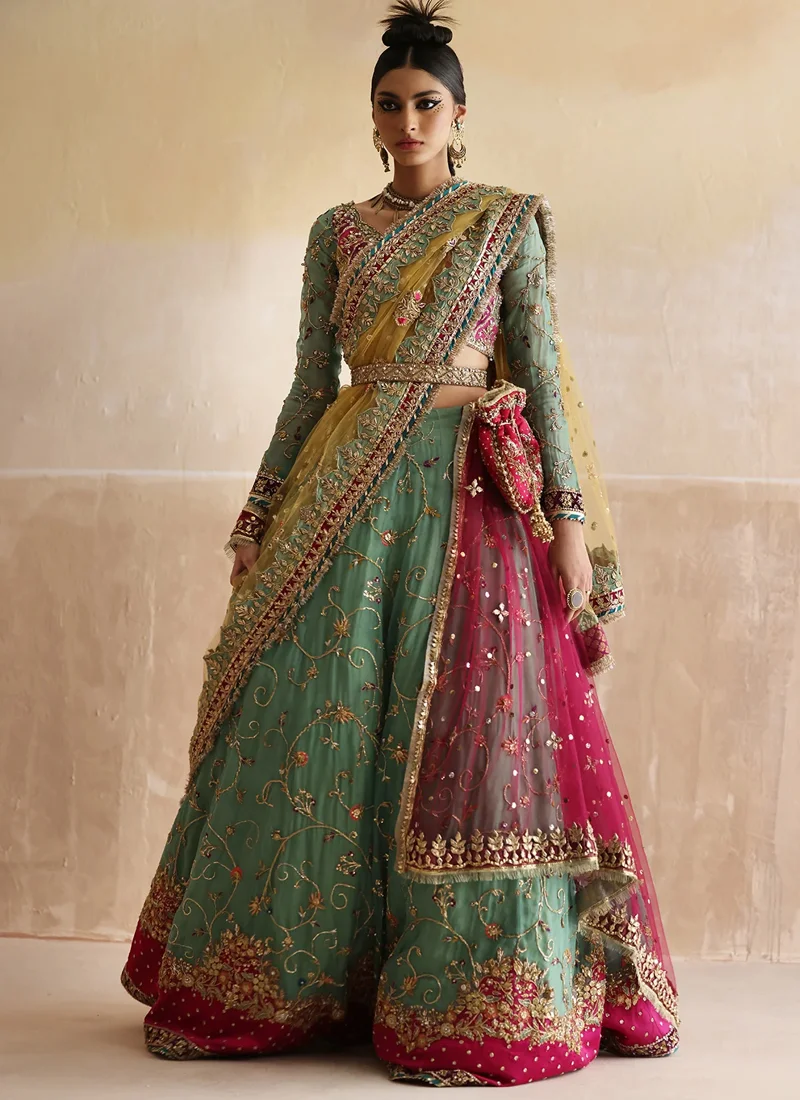 Sea Green Mehndi Lehenga Choli with Hot Pink Floral Hem Sea green mehndi lehenga choli front view with gold vine embroidery, hot pink floral hem and yellow dupatta
