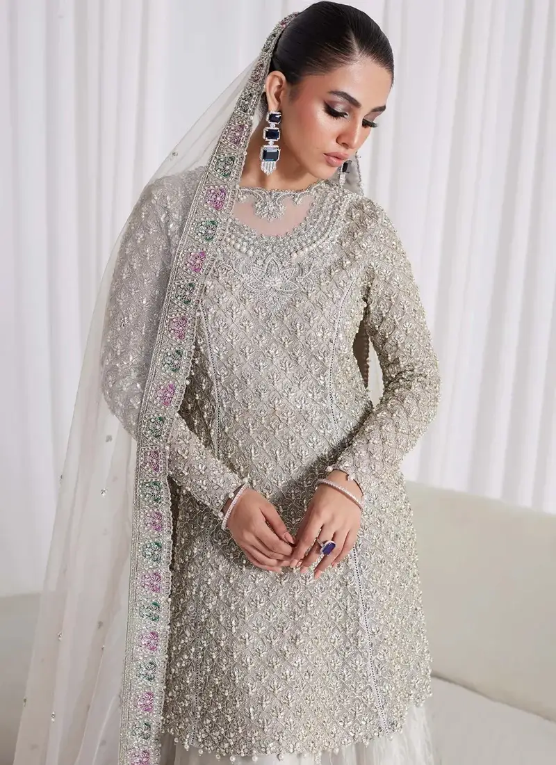 Silver Nikkah peplum frock side close-up with dense floral embroidery and sheer embellished dupatta