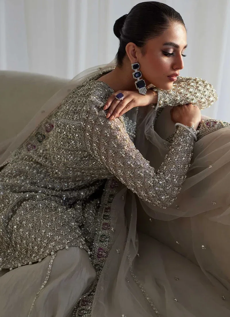 Silver bridal peplum frock front detail showing an illusion neckline and pink-green dupatta border